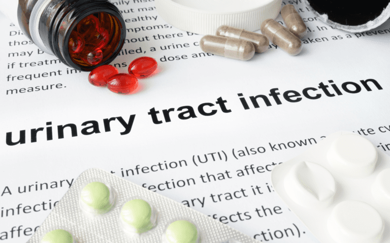 Urinary Tract Infection research information written in a copy paper surrounded with several medicines.