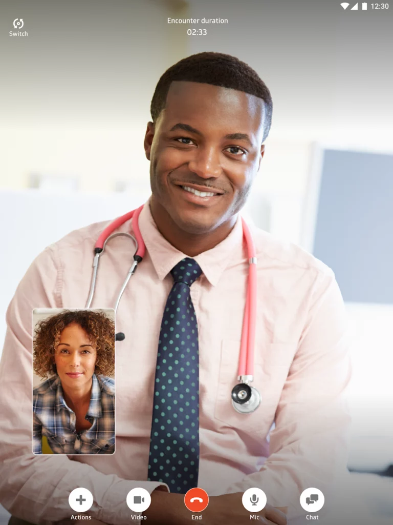 Image of a young male doctor wearing light pink stethoscope and polo during a video call consultation with a young female patient.